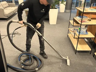 Premier technician deep cleaning carpet with an extraction machine